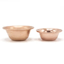 Copper offering bowls arranged on a shrine
